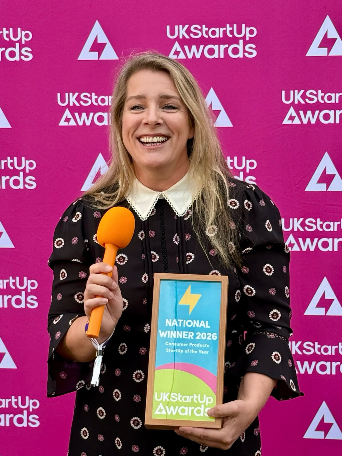 Darcey Croft, ISOMUM founder, holding the UK StartUp Awards 2026 national winner plaque at the awards ceremony